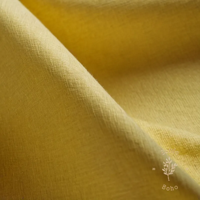 Organic cotton fabric with stains and a clean, spotless section.