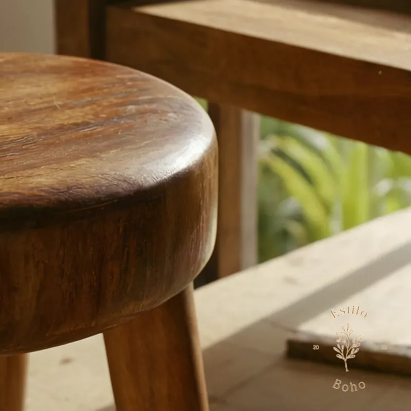A close-up of a mango wood stool's legs being cleaned.